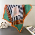 Detail of colorful geometric silk scarf with hand-rolled edges on a designer handbag - 66-70cm / Green