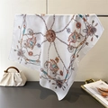 Detail of silk-like scarf featuring vintage horse carriage and chain pattern prints - White