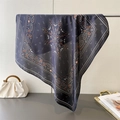 Navy blue paisley silk scarf with orange floral pattern hanging on a metal bar - 70cmx70cm / Black