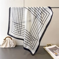 Close-up of silk scarf with geometric black lines draped on a metal stand for soft texture - White / 70cmx70cm