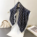 Elegant satin square scarf with geometric line prints draped on a white mannequin - Black / 70cmx70cm
