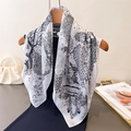 Elegant silk-like square scarf with monochrome forest print hanging on a wooden hanger - Black Grey Artistic Forest (FG345-2)