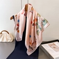 Pink silk square scarf with butterfly and floral print hanging on a wooden hanger - Light Pink / 70cm