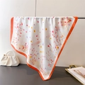 Close-up of floral silk scarf with orange borders draped next to a pearl handle bag - 66-70CM / Orange Border