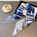 Detail of silk skinny scarf with horsebit chain print and floral patterns on grey surface - Dark Blue with Light Blue (LE-301)