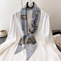 Detail of retro chain pattern silk scarf styled with a white shirt and camellia hanger - Grey Blue with Yellow (LE-302)