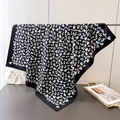 Detailed texture of black floral silk scarf with white butterfly patterns on a rack - White Black Floral (FN276-2) / 90x90cm / Black and White