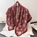 Vintage burgundy silk scarf with camellia print draped on a white blazer - Red