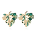 Hollow gold leaf stud earrings with green and clear rhinestones on white background - Multicolor