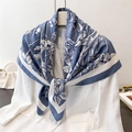 Elegant floral silk-like square scarf in navy blue and white on a white blazer - Haze Blue