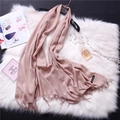 Detail of pink cashmere scarf with fringe hem next to pearls and fashion accessories - Cinnamon (FYR150-20)
