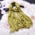 Detail shot of soft olive green cashmere scarf with fringe tassels on plush background - Yellow Green (FYR150-24)