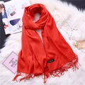 Detail of bright orange cashmere scarf showing soft texture, fringe edges and woven label - Orange-Red (FYR150-06)