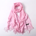 Close-up of pink cashmere scarf with fine tassels and a soft, lightweight texture - Pink