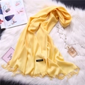 Detail of yellow cashmere scarf with fringe tassels and fabric label on fur rug - Bright Yellow (FYR150-23)