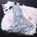 Close-up of soft light blue cashmere scarf with fringe edges and quality label - Light Gray (FYR150-17)