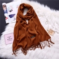 Detail shot of a caramel cashmere scarf with fringes and quality brand label - Caramel (FYR150-14)
