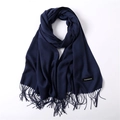 Close-up of deep blue cashmere shawl with soft fringe details and authentic quality label - Navy Blue