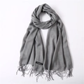 Close-up of soft grey cashmere scarf texture with delicate fringe edge detail - Heather Grey