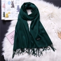 Detailed view of dark green cashmere scarf with fringe and a classic fabric label - Dark Green (FYR150-28)