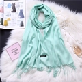 Close-up of mint green cashmere-feel scarf with elegant fringe detail on soft white fur - Mint Green (FYR150-27)