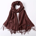 Detail of burgundy cashmere shawl showing woven texture, fine tassels and label - Coffee