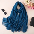 Detail of thin peacock blue silk scarf styled with sunglasses and evening clutch - Cyan Blue