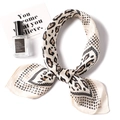 Detailed close-up of leopard print satin silk scarf with elegant knotting and soft texture - 70x70cm / Off White (FJ7-2)