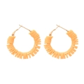 Detailed close-up of apricot heishi clay bead hoop earrings with gold leverback closure - Orange