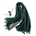 Close-up of dual-color dark green and grey scarf with fringe next to fashion magazine - 200x65cm / Dark Green And Gray (WJ32-37)