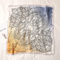 Detailed macro view of the soft paisley silk scarf with elegant orange to blue gradient - Blue & Yellow