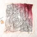 Macro detail of silk-like paisley square scarf with pink gradient and mandala patterns - Red-Pink Gradient