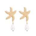 Gold starfish drop earrings with baroque pearl pendants in a minimalist ocean vacation style - Gold