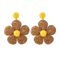 Detail of handmade raffia flower earrings in yellow and brown bohemian weave style - Camel