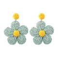 Macro detail of hand-woven raffia flower earrings in mint green and yellow colors - Light Blue