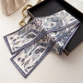 Detail of vintage horse pattern silk scarf draped over a black tray and handbag - Grey Purple Steed Totem Style (LJ21-H262) / 145x12cm