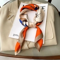 Elegant orange silk scarf with horse harness print styled on a beige suit jacket - 70*70cm / Orange