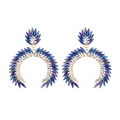 Macro detail of geometric C-shaped earrings with colorful crystals and rhinestones - Blue