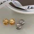 Minimalist square metal stud earrings in polished gold and silver finishes on a tray - Silver