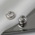 Detailed view of polished silver wide hoop earrings on silk and reflective base - Silver(G104)