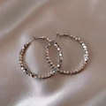 Close-up of silver geometric polyhedron bead hoop earrings on beige silk fabric - Large Beaded Style / Silver (Style 3)