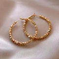 Detailed close-up of golden hoop earrings with faceted geometric beads on satin - Large Beaded Style / Gold (Style 3)