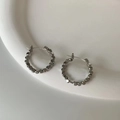 Close-up of geometric textured silver hoop earrings on a white ceramic display tray - Polyhedron Beaded Style / Silver (Style E327)