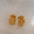 Detailed view of irregular woven 18K gold hoop earrings on a minimalist white paper background - Gold