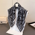 Detailed view of paisley and floral pattern on lightweight black and white scarf - Black