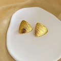 Dettaglio di orecchini triangolari placcati oro 18K con finitura ruvida su vassoio - Oro (G209)
