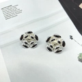 Macro detail of silver camellia flower earrings on a minimalist white magazine background - Five-Petal Flower Style (2E209) / Silver