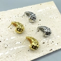Detail view of gold and silver waterdrop earrings with hammered texture on stone base - Medium-26MM / Gold