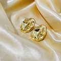 Irregular textured gold lava earrings displayed on elegant silk fabric background - Gold Oval