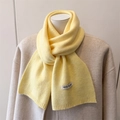 Close-up of soft wool blend knit scarf in light yellow with woven brand label detail - 164x22cm / Yellow (WT282-11)